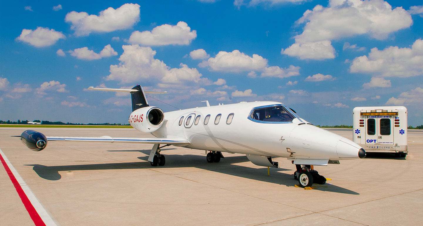 bombardier learjet and ambulance on runway